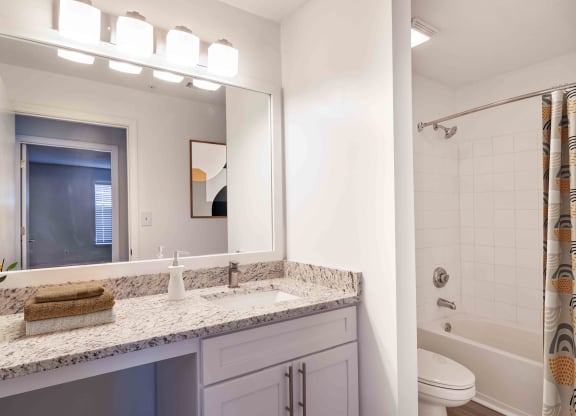 Renovated bathroom with vanity and shower at Elme Eagles Landing in Stockbridge, GA