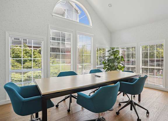 A conference room with a large table and chair at Elme Alexandria, Alexandria, 22304.