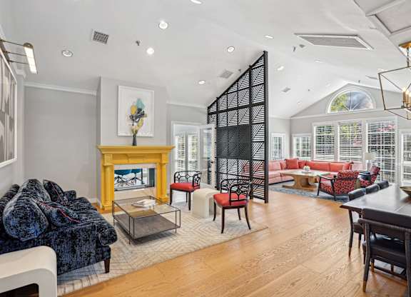 A living room with a fireplace and a dining table at Elme Alexandria, Alexandria, 22304