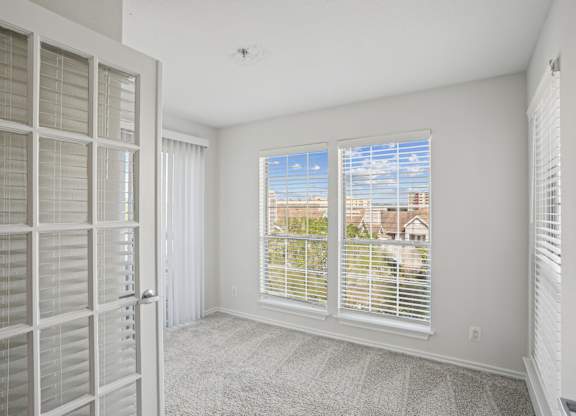 A room with a view of the outside through the window.