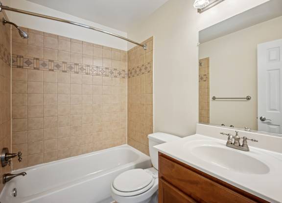 A bathroom with a white tub, toilet, and sink at Elme Bethesda, Bethesda, 20814