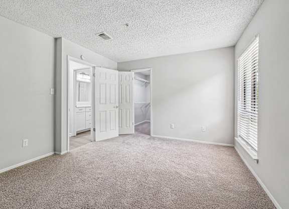 A room with a carpeted floor and white walls.