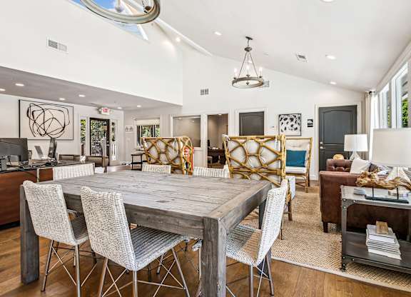 A modern dining room with a wooden table and chairs.