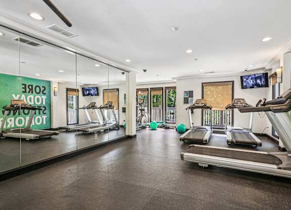 A gym with treadmills and exercise equipment.