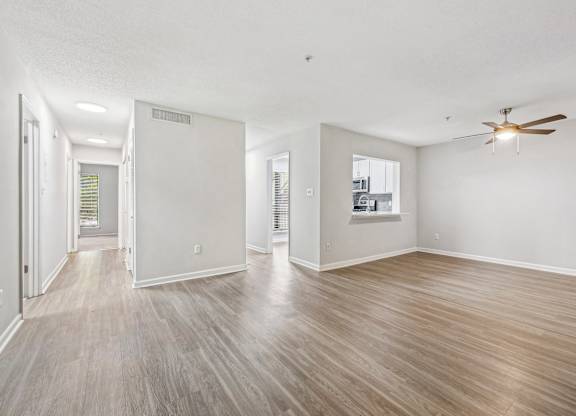 A room with a ceiling fan and lighting fixture.