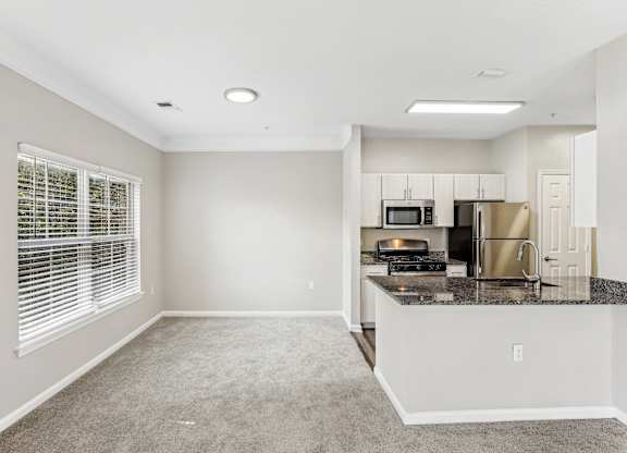 A kitchen with a microwave, oven, and refrigerator at Elme Dulles, Herndon, VA