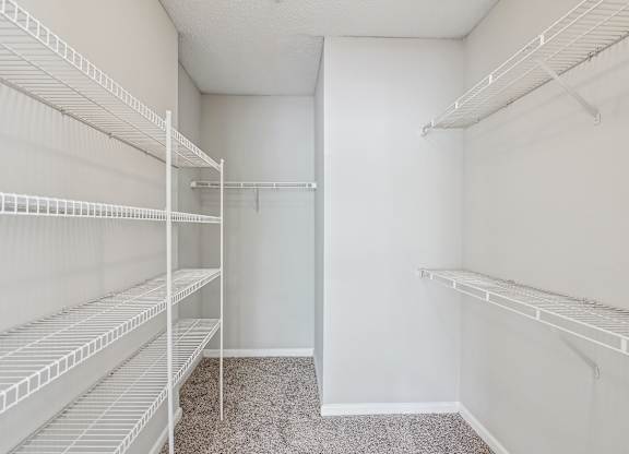 Empty white shelves in a room.