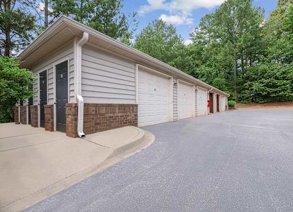 A two-car garage with a brick pillar and a black door.