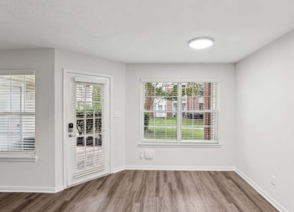 A room with a window and a door.