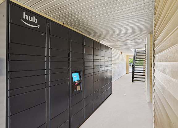 A long hallway with a row of Amazon storage units on the left.