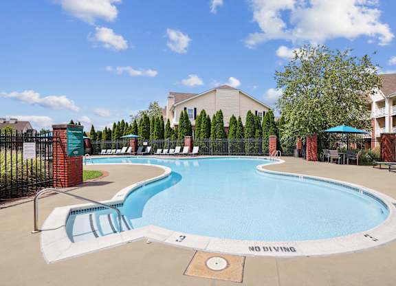 A pool with a slide and a sign that says