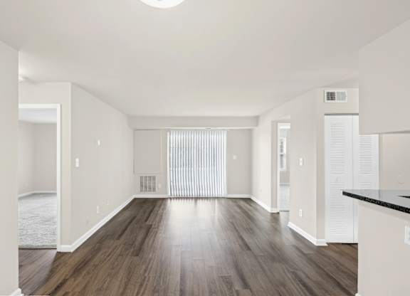A spacious room with wooden floors and white walls at Elme Leesburg, Virginia, 20176