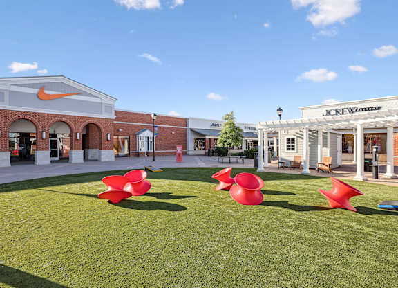 A grassy area in front of a building with a Nike logo on it.