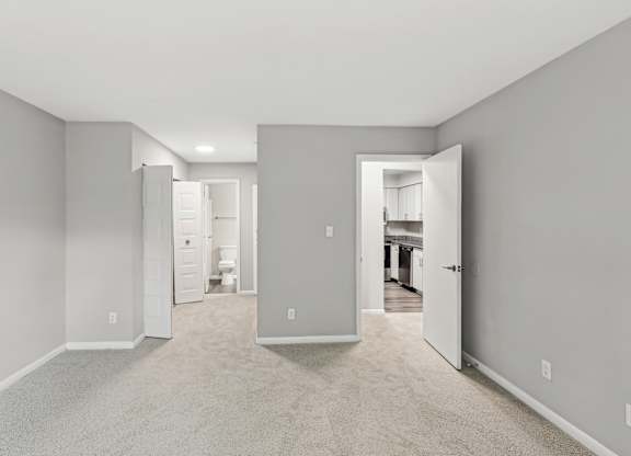 A room with white walls and carpeted floor with a doorway leading to another room at Elme Manassas, Manassas, 20109