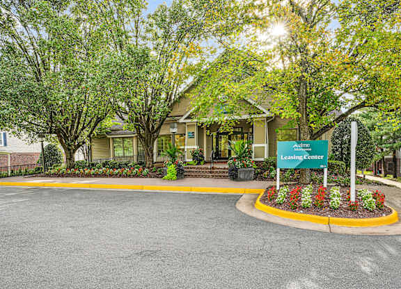 A leasing center is surrounded by trees and plants.