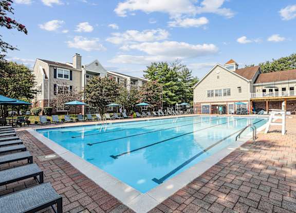 A large swimming pool surrounded by benches and trees at Elme Manassas, Manassas, 20109