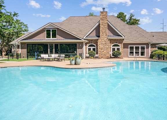 A house with a pool in front of it at Elme Marietta Apartments, Marietta, GA
