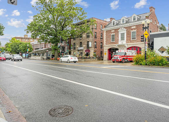 A street view with cars, buildings, and a fire truck.