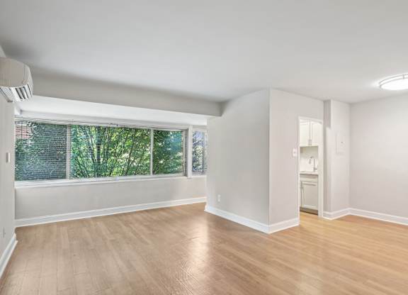 A room with wooden floors and white walls The Kenmore, Washington, 20015