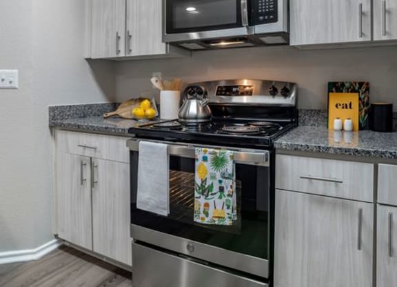 Renovated kitchen with stainless steel appliances and granite countertops at Elme Alexandria, Virginia