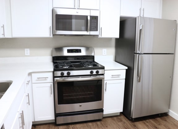 Renovated Kitchen with stainless steel appliances and quartz countertops at Elme Cumberland Apartments, Smyrna, Georgia
