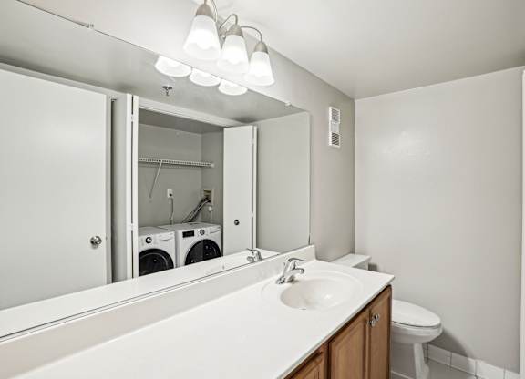 A bathroom with a white sink and a mirror  at The Paramount, Arlington, Virginia