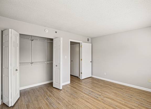 A room with a white door and a wooden floor  at The Paramount, Arlington, Virginia