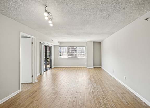 A room with wooden floors and a window.