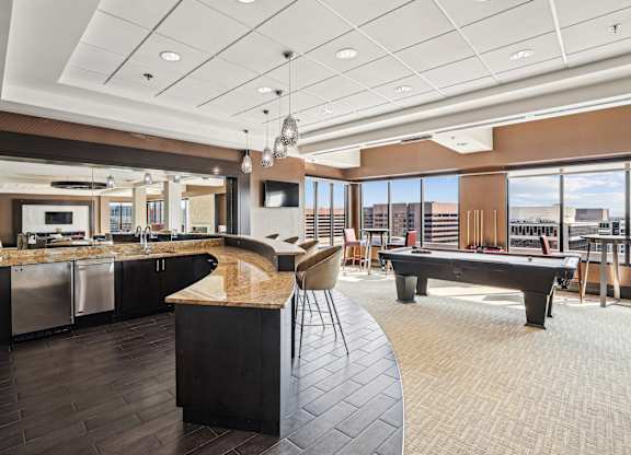 A modern kitchen with a pool table.