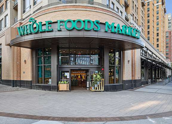 A Whole Foods Market storefront with a green awning and a sign above the entrance.