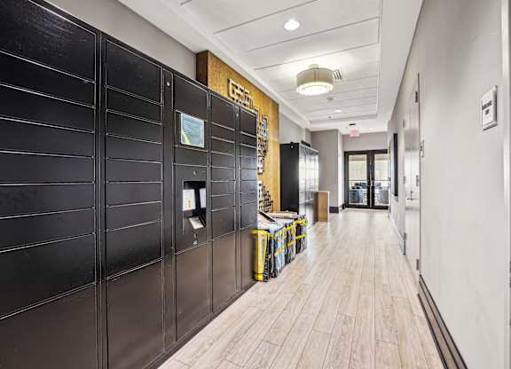 A long hallway with a black wall on the left and a wooden floor  at The Paramount, Arlington, Virginia