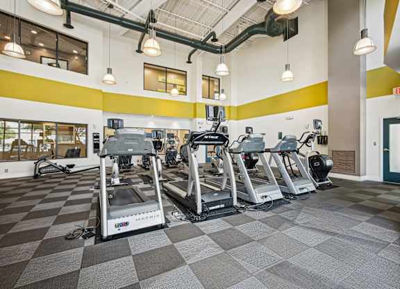 A gym with treadmills and elliptical machines at Riverside Apartments, Alexandria, Virginia