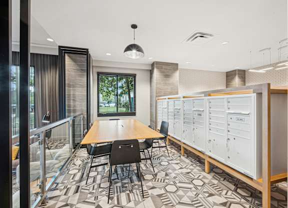 A conference room with a long table and chairs, a whiteboard, and a window with curtains.