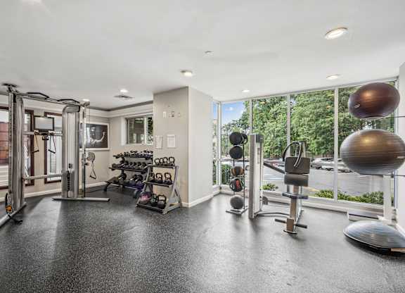 A spacious home gym with a variety of exercise equipment  at Roosevelt Towers, Falls Church, VA