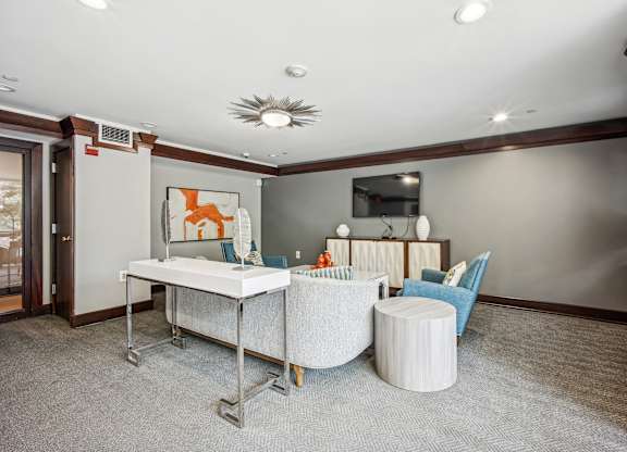 A room with a white desk and blue chairs  at Roosevelt Towers, Falls Church, VA
