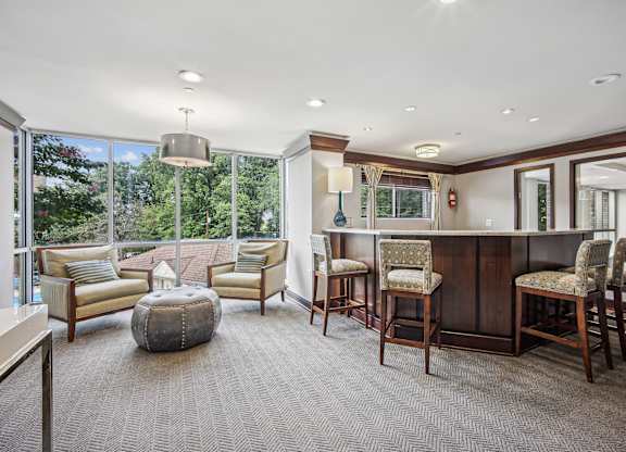 A well-lit room with a bar and comfortable seating  at Roosevelt Towers, Falls Church, VA