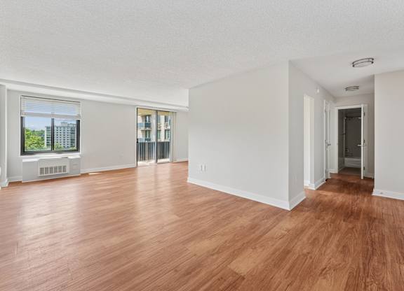 A room with wooden floors and white walls.