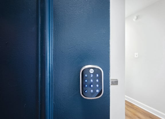 Blue door with smart lock at Roosevelt Towers Apartments, Falls Church, Virginia