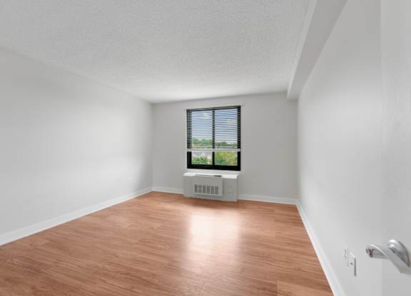 A room with a window and a radiator on the floor  at Riverside Apartments, Alexandria, Virginia