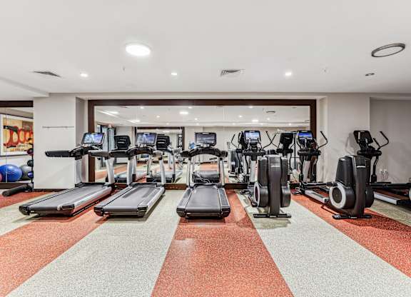 A gym with treadmills, exercise bikes, and elliptical machines at The Maxwell Apartments, Arlington