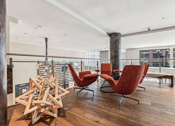A room with a wooden floor and a white ceiling with a star-shaped object on the floor at The Maxwell Apartments, Arlington