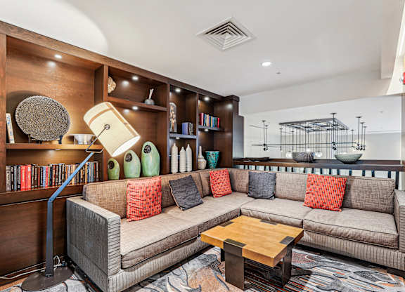 A living room with a grey couch and a wooden coffee table.