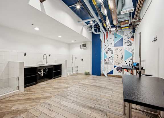 A room with a wooden floor and a mural on the wall.