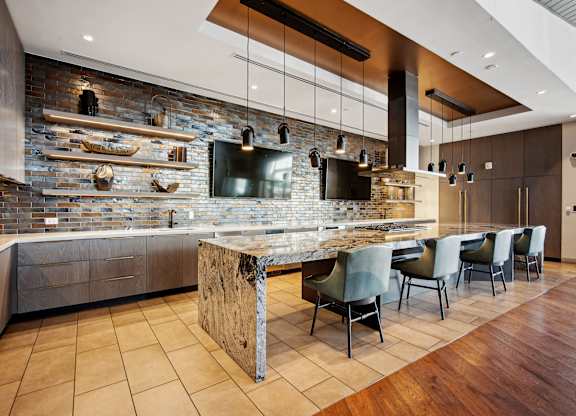 A modern kitchen with a stone backsplash and a central island.