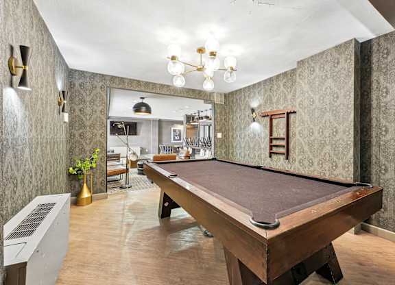 A pool table is in the middle of a room with a vintage feel at Wellington Apartments, Arlington, Virginia