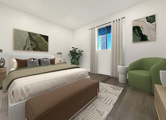 A bedroom with a large bed and a green armchair.
