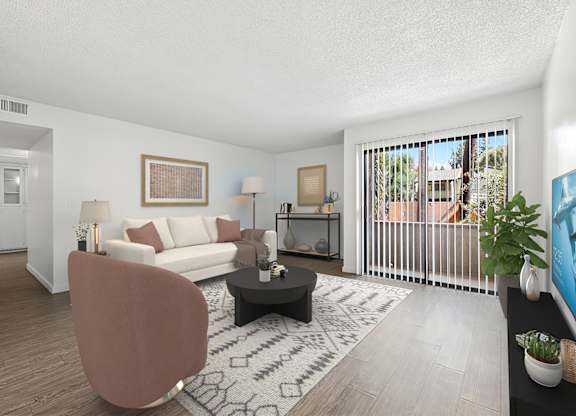Spacious living room in 1005 Via Zapata apartment home with wood-style plank flooring and sliding doors leading to private patio