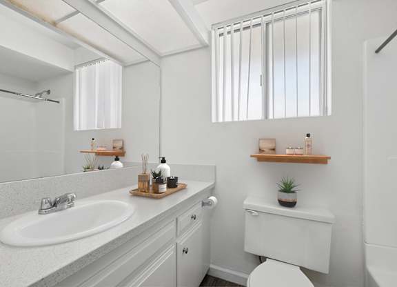 Bathroom in 955 Via Zapata apartment home with wood-style plank flooring, vanity station enclosed room with additional sink vanity, toilet and a shower/tub