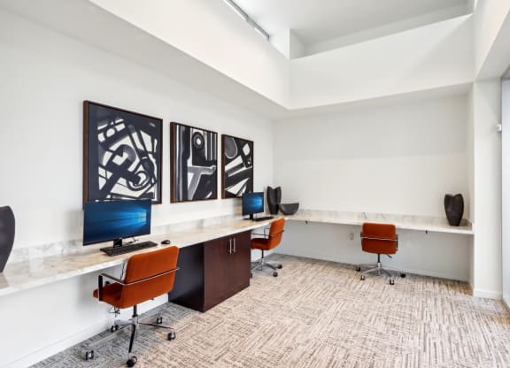 a large office with desks and chairs and a window at The Max on Jefferson Apartments, Murrieta, 92562