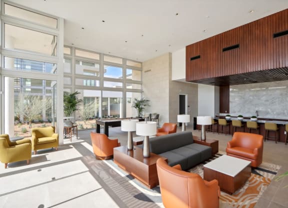a rendering of a large lobby with couches and chairs at The Max on Jefferson Apartments, Murrieta, CA, 92562